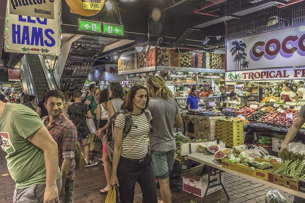People walking through a busy indoor market