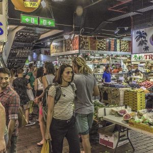 People walking through a busy indoor market